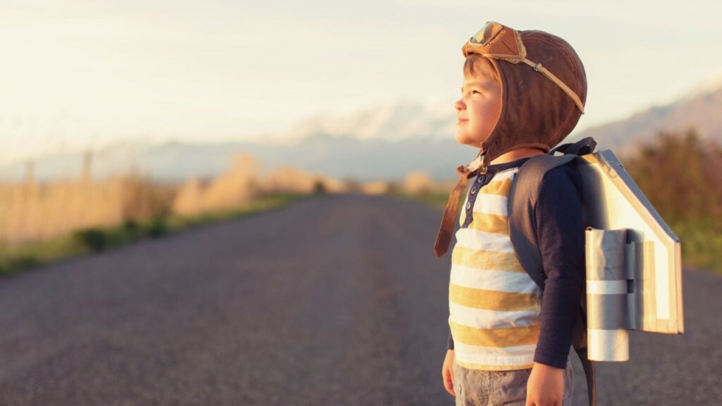 Illustrative picture showing child looking to the future with home made rocket.